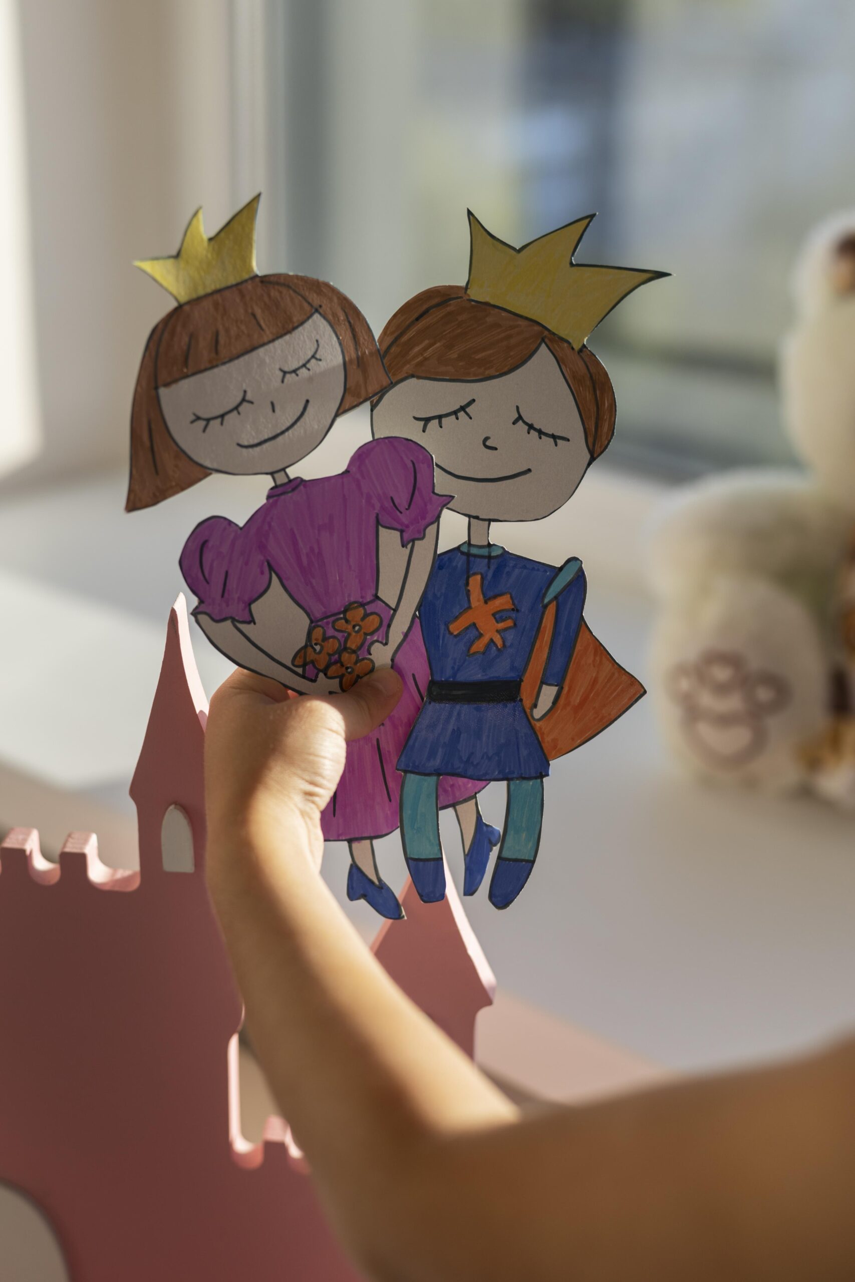 adorable little girl playing with her puppets home