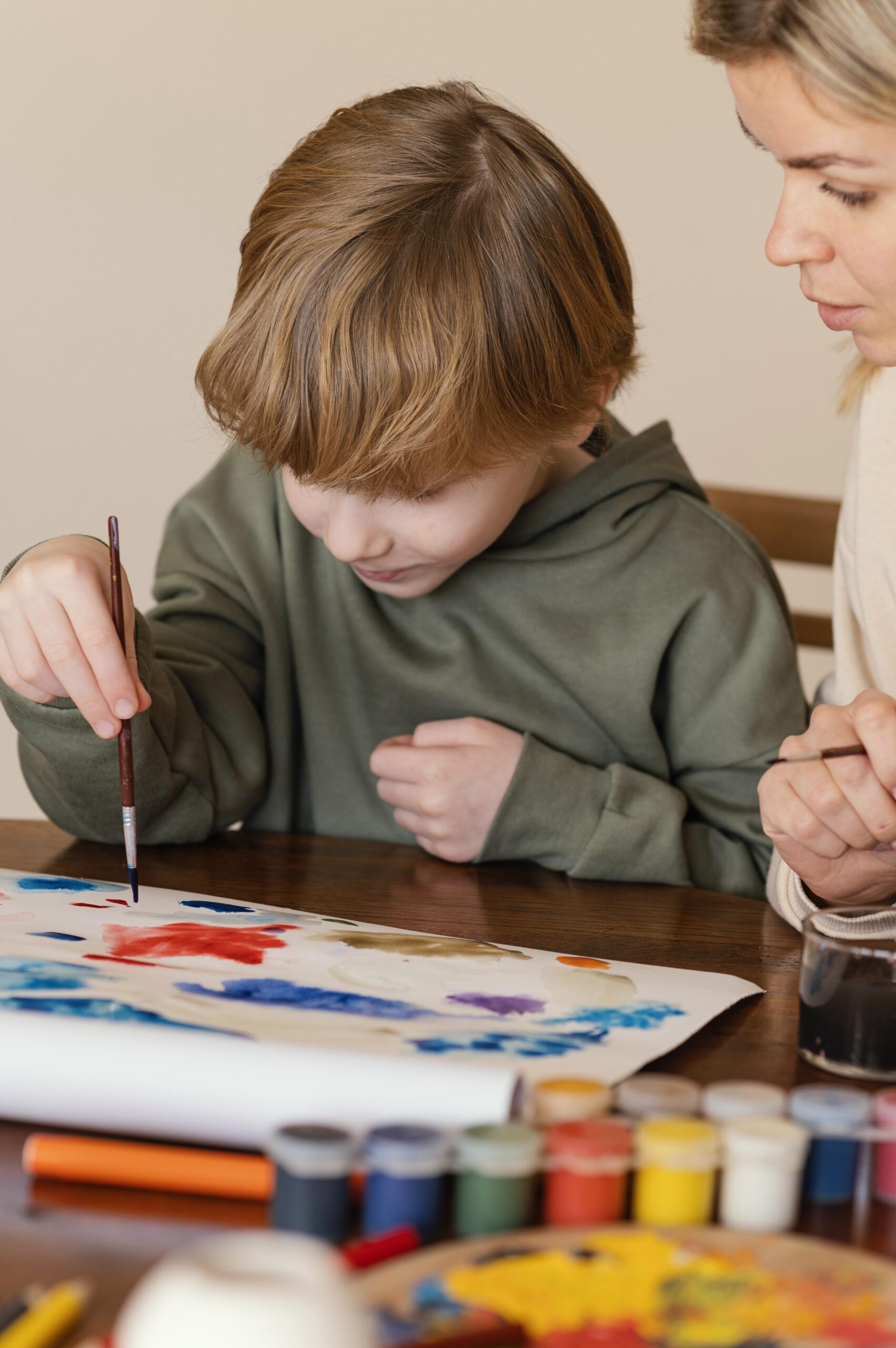 close up woman kid painting paper