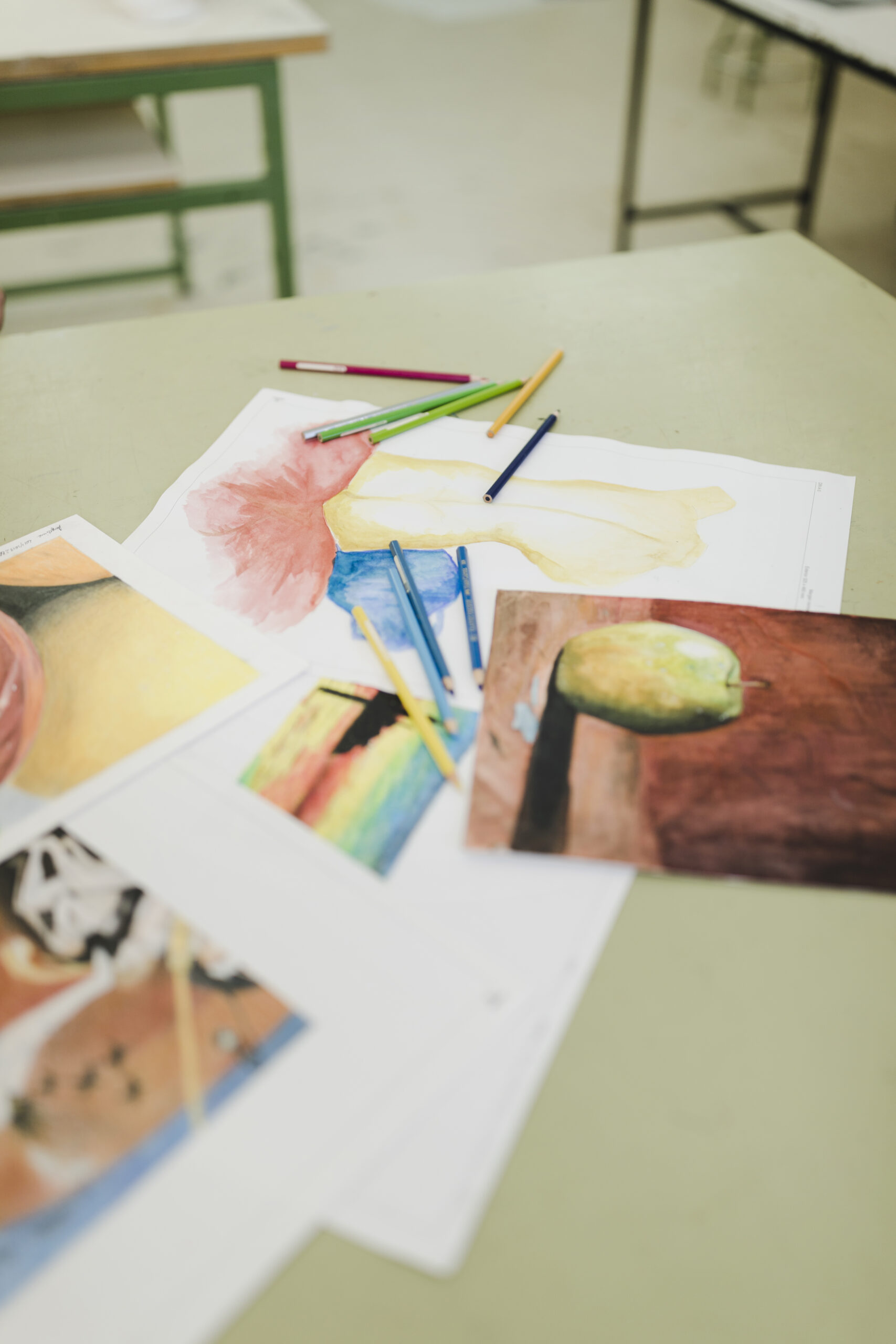 various painting paper colored pencils table